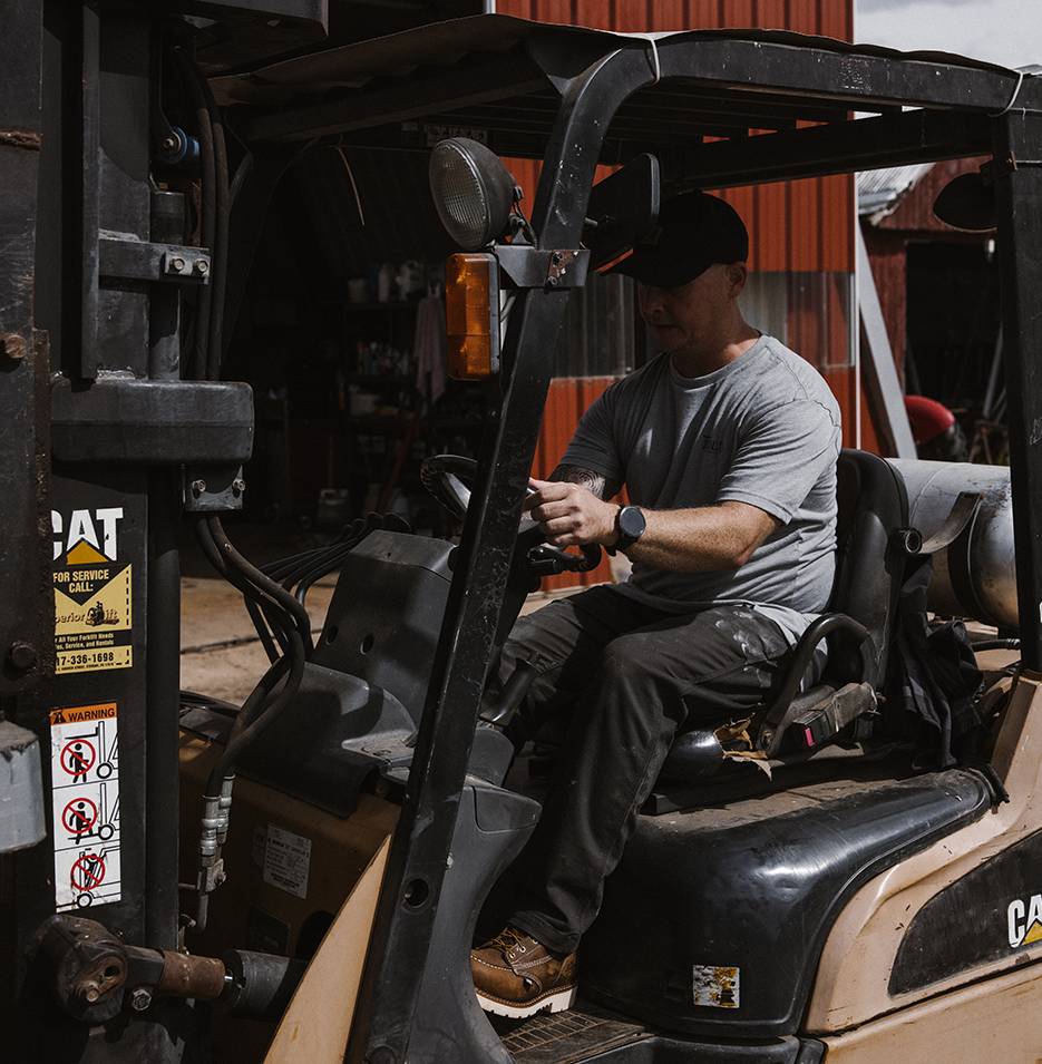 Worker driving heavy machinery